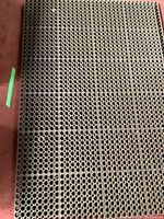 Top view showing circular hole pattern of rubber floor mat