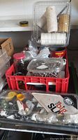 Photo of multiple jars and plastic containers holding screws and nails inside a red plastic crate, with white twine rolls stacked on top.