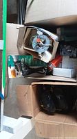 Box with assorted mounts, wiring, and camera units including some lights.
