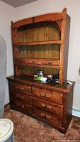 Front view of the Link-Taylor dresser with upper hutch showing drawers and shelves, and some items on the top surface.