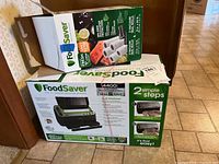 Original box of FoodSaver 4400 Series 2-in-1 Food Preservation System, with product information and branding visible.