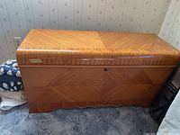 Closed view of the Lane cedar chest showing wood grain pattern and lock on the front