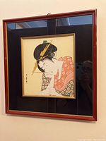 Full view of geisha portrait in red frame with black mat