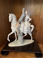 Front left perspective showing riders and horse details