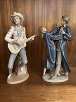 Front view of both figurines on wood background