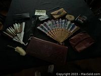 Overview of fans and leather accessories on black background