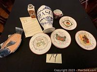 Overall view of DIASCO vase with assorted plates and ceramic items on table