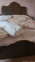 Bed frame with headboard, mattress and quilt in assembled view