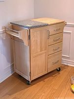 Front-right-side view showing two-part top, drawers, cabinet, towel rack and casters