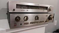 Stacked Luxman T-1 tuner above L-235 amplifier