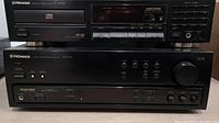 Front view of Pioneer PD-5700 CD player on top and Pioneer VSX-305 receiver below, showing front panels with buttons and knobs.