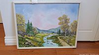 Full view of the original oil painting showing the landscape scene with river, trees, and mountains.