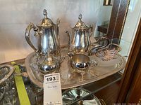 Full view of silver plated tea set arranged on ornate serving tray with swan dish included