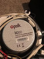 Close up of Polk Audio IC60 speaker rear with branding and model info