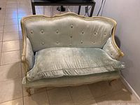 Vintage mid century loveseat settee with light green velvet upholstery, button tufted back, loose seat cushion, carved wooden frame and cabriole legs