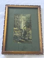 Framed antique watercolour painting showing full frame ornate gold plaster with green matting and mounted forest waterfall scene.
