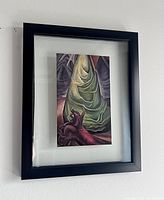 Framed print hanging on the wall with clear view of the black floating frame and artwork.