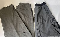 Two-piece lot of men's Lululemon gray pants and gray shorts laid flat, showing overall condition and style.