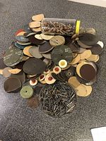 Photo showing overall assortment of Dremel sanding, grinding, buffing and cut off wheels piles and containers of rotary bits.