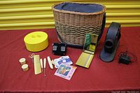 Full view of all items including basket, stapler, scissors, combs, mirror, slide viewers, yellow container