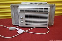 Front view of the Danby window air conditioner showing the front air vents, control knobs, and attached power cord.