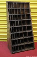 Front view of the wooden cabinet showing compartments and measurement markings on the left side.