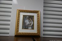 Frontal view of the framed pastel artwork depicting mother holding daughter, showing frame and artwork details.