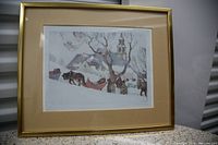 Framed winter scene print showing snowy landscape, horses, people, and distant steeple