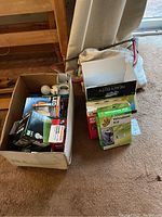 Photo showing box with assorted light bulbs, LED bulb packaging, small white spherical bulb, and other small accessories.