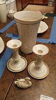 Photo showing the large embossed porcelain vase, two matching candle holders, and the small swan figurine together on a table