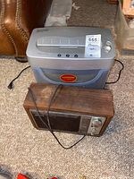 Executive paper shredder and vintage Sony radio together on carpeted floor