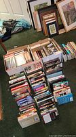 Books organized on carpet, showing large quantity and varied titles and formats including hardcover and paperback.