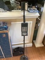Full view of Bounty Hunter Tracker II metal detector standing upright showing the entire shaft, coil, armrest, and control box.