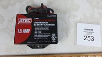 Top view of ATEC battery charger showing brand, model 9002, 1.5 AMP, and product details.
