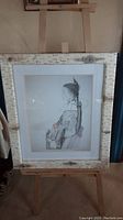 Full view of the framed pencil sketch on stand, showing frame style and overall size.