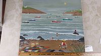 Full view of the large 24x24 inch oil painting showing the folk-art seaside scene with boats on water, shoreline, beach blanket with baskets, playing children, and coastal landscape.