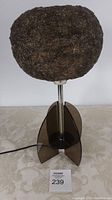 Front view of mid century table lamp showing the spaghetti fiberglass shade and four-paneled acrylic base.