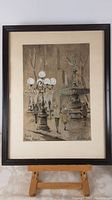 Framed original painting of Paris Place Royale shown in full with easel for scale.