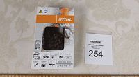 Photo of new Stihl chainsaw chain in original box, showing front packaging with chain visible inside.