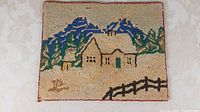 Full view of the hand hooked mat showing the winter house scene, measuring approximately 13 x 16 inches.