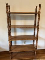 Front view of wooden bookcase with five adjustable shelves.