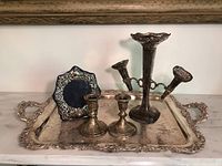 Overall view of the tray holding candlesticks, picture frame, and filigree vase