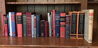 Shelf of over 20 vintage veterinary books with various titles and bindings.