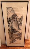 Full view of framed watercolor painting showing mountainous landscape with traditional Asian architectural elements and pine trees.