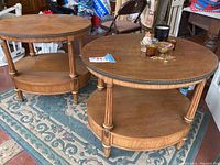 Pair of round wooden end tables showing overall shape, features and condition.