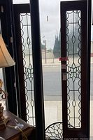 Two rectangular wood-framed clear beveled frosted leaded glass panels side by side
