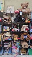 Full view of 15 cubby wire shelves filled with assorted toys, puzzles, stuffed animals, hats, and other items.