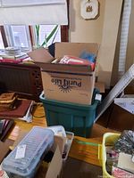 Boxes and bins with crafting and sewing items in a room setting