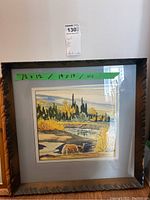 Photo of the framed watercolour artwork showing the front with visible matting and frame, including green tape with size notes 12x12 and 19x19, and price tag.