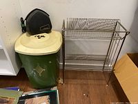 Wide shot of record cleaner on laundry basket, metal record holder on floor